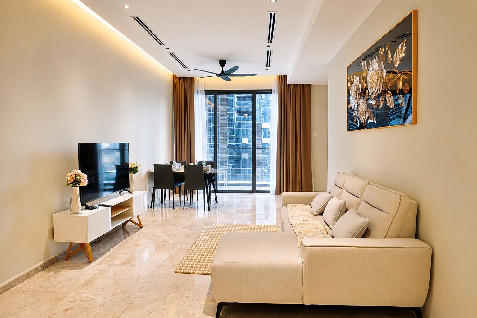 A modern living room with a flat-screen TV, a sofa, a dining area with chairs, and a large window with a city view.