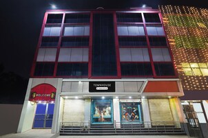 A multi-story building with a sign reading 'TOWNHOUSE Company Serviced'.