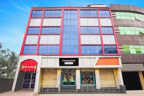 A multi-story building with a sign reading 'TOWNHOUSE' and a 'WELCOME' sign above the entrance.