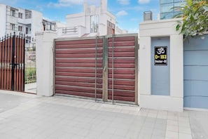 A gated residential area with a closed metal gate and a sign indicating a sector number. - Townhouse Oak Sector 51 Noida (Noida)