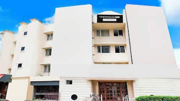 A multi-story building with a sign indicating it is company-serviced.