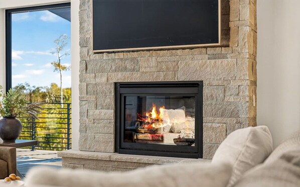 Cozy up by the fireplace and enjoy a relaxing evening in the spacious living room.