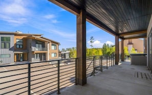 Enjoy the fresh air from the covered terrace while taking in views of the surrounding neighborhood and landscape.