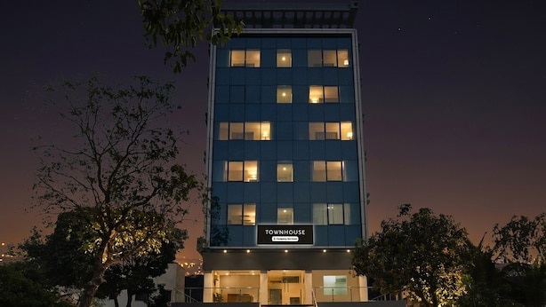 A multi-story building with a sign indicating it is a townhouse.