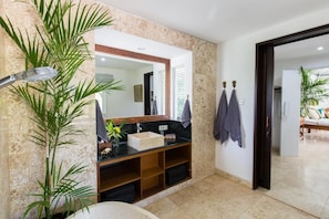 A bathroom with a marble sink, a large mirror, and a potted plant. - 4 bedroom villa in Canggu, 2 minutes walk to the beach (canggu)