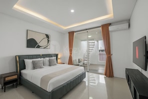 A modern bedroom with a large bed, a flat-screen TV, and a sliding glass door leading to a staircase.