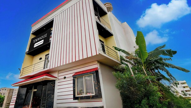 A multi-story building with a sign indicating 'TOWNHOUSE Company-Serviced.' - Townhouse Puri Sea Beach (Puri)