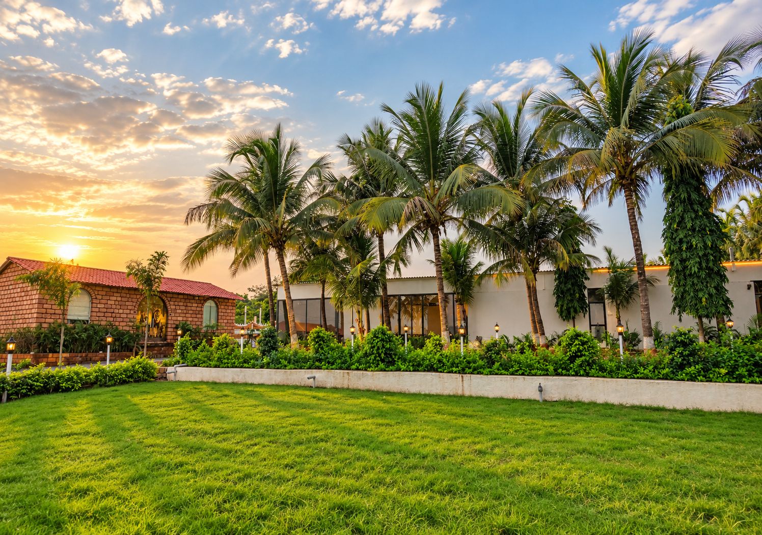 A hotel with a brick facade, palm trees, and a well-maintained lawn.