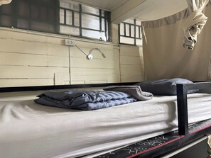 A bunk bed with a mattress, pillows, and a headboard. - Atlas Hostel Khaosan (Bangkok)