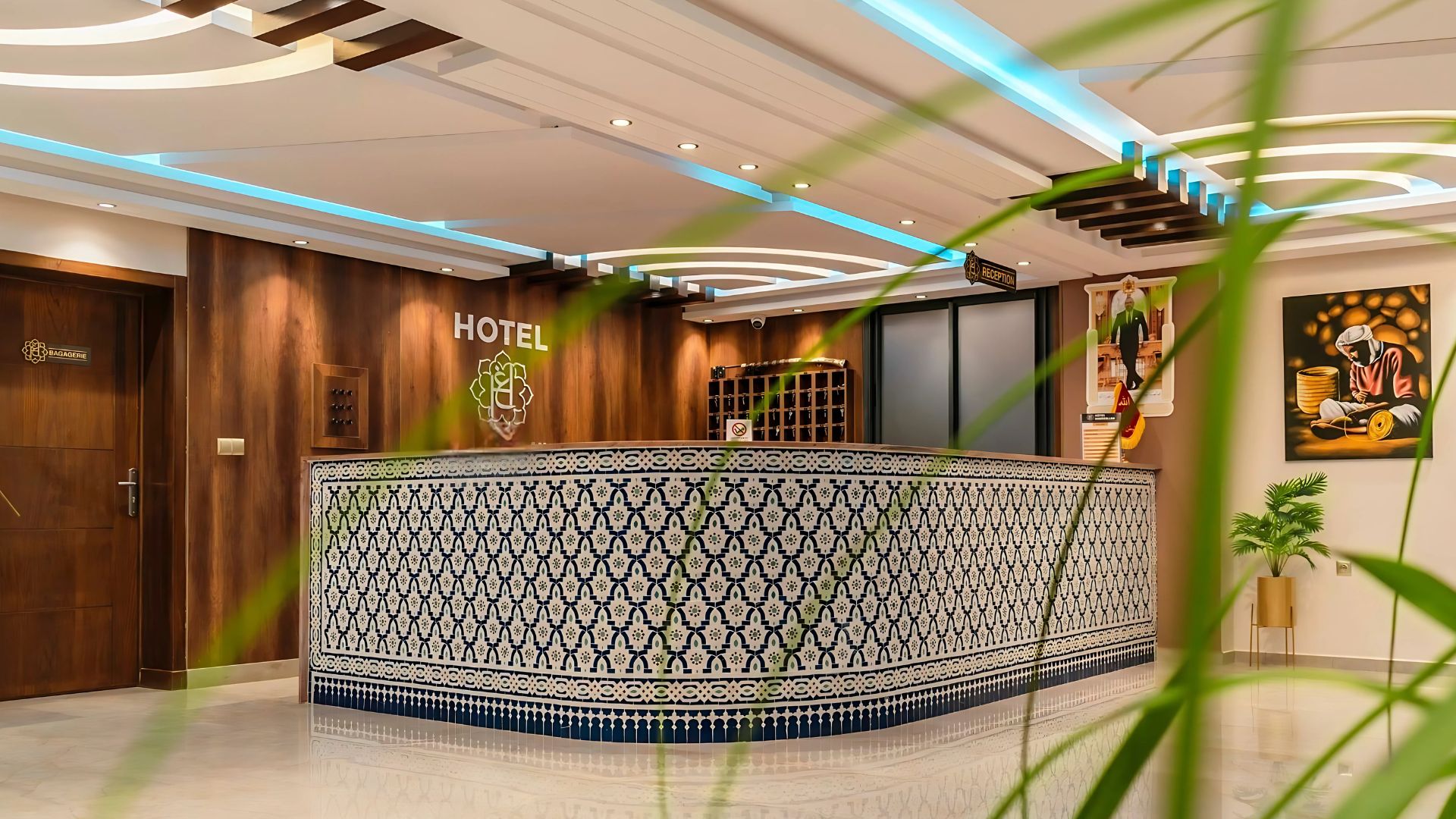 A hotel reception area with a patterned reception desk, a reception sign, and a wall-mounted security camera.