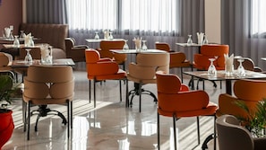 A modern dining area with multiple tables and chairs, some with glassware and napkins. - Hotel Rherssllah (Zaio)