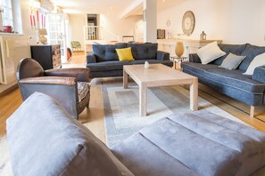 A modern living room with a sofa, armchair, and coffee table.