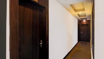 A hallway with a wooden door labeled '1003' and a door labeled '1001' at the end.