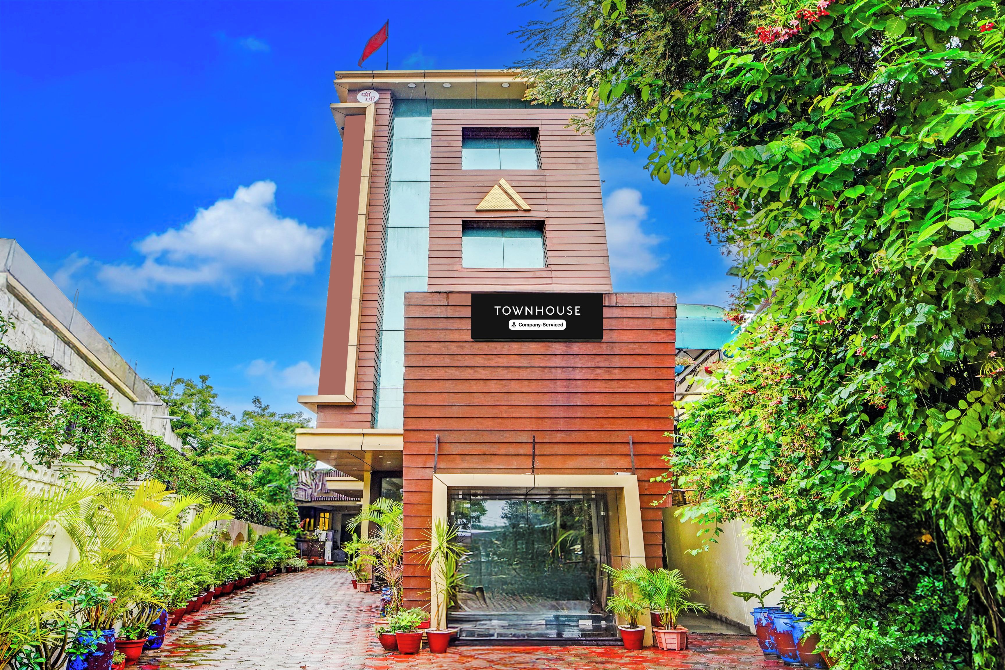 A modern townhouse with a sign indicating it is company-serviced.