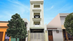 A multi-story building with a sign indicating it is a townhouse. - Townhouse Puri Shri Jagannatha Temple (Puri)