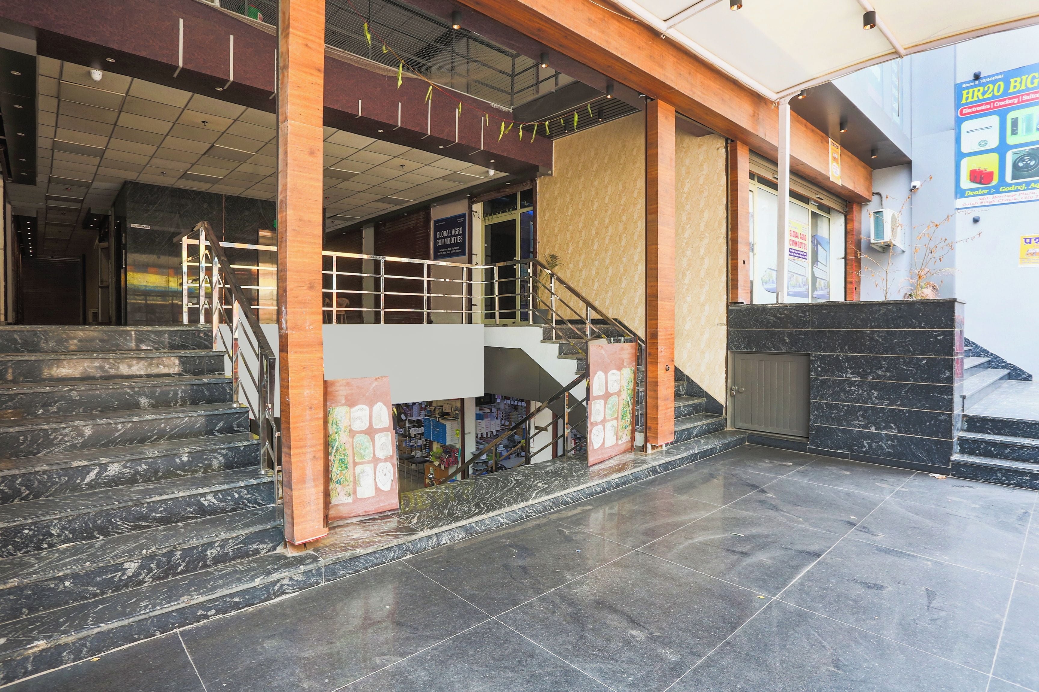 A building entrance with a staircase leading to an upper level.