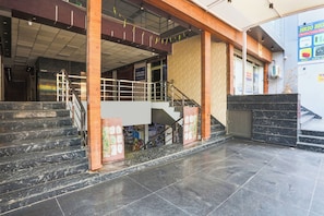 A building entrance with a staircase leading to an upper level.