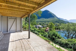 Un espace extérieur abrité offrant une vue sur une montagne et un lac.