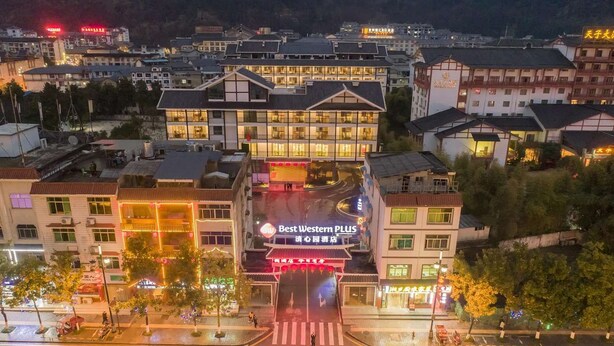 Un hotel con un letrero destacado que dice 'Best Western PLUS' y un edificio moderno de varios pisos.