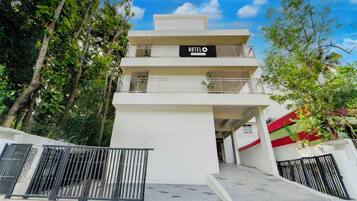 A multi-story hotel with a sign reading 'HOTEL' and 'Company Serviced.'