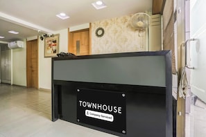 A reception desk with a sign reading 'TOWNHOUSE Company Serviced'.