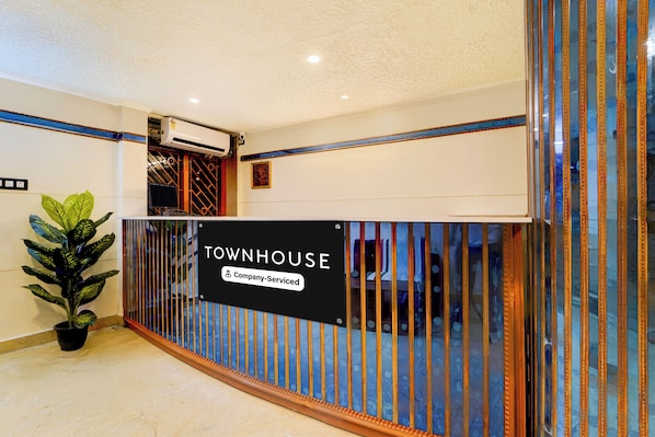 A reception area with a sign reading 'TOWNHOUSE Company Serviced'.