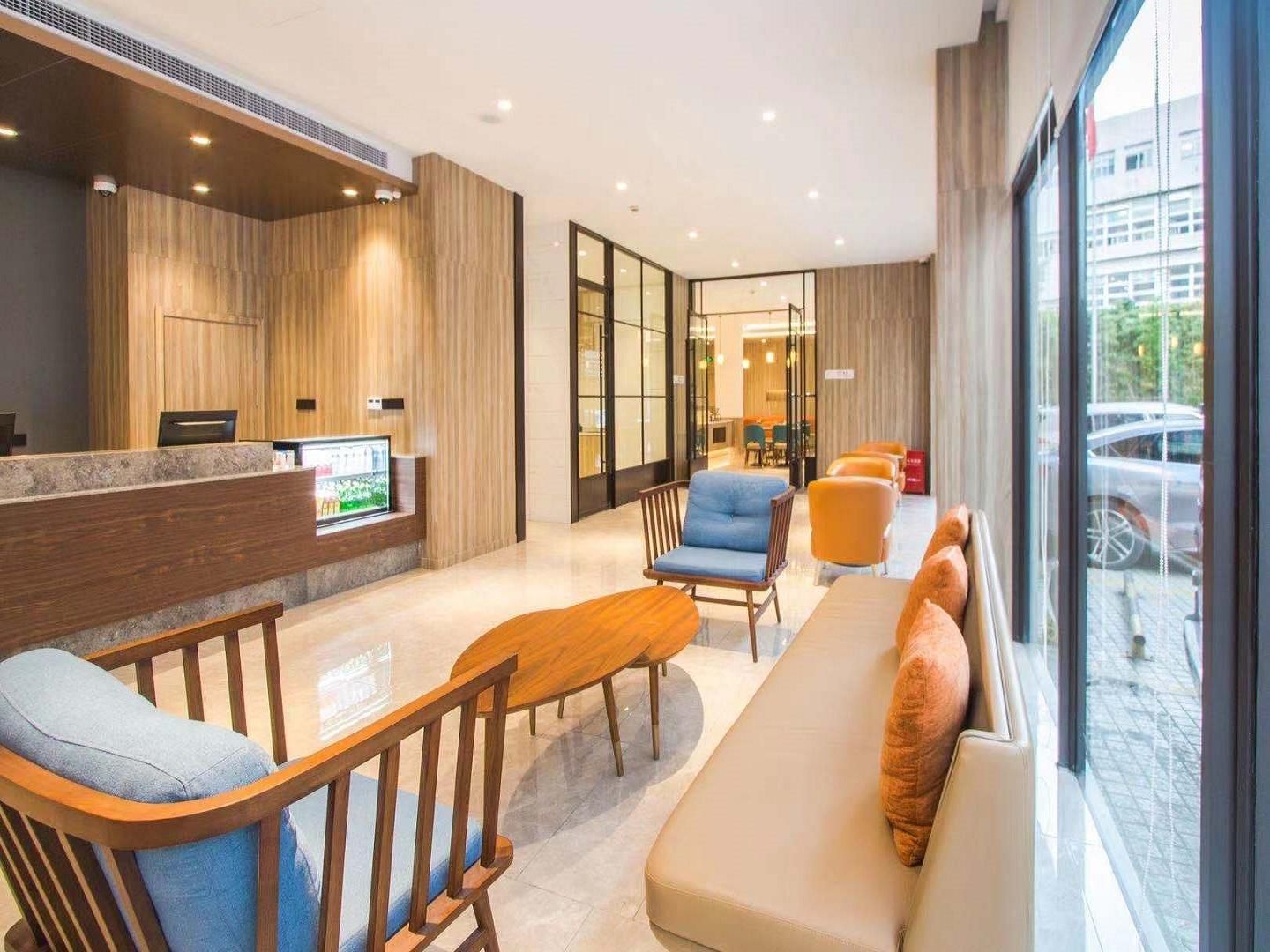 A modern reception area with a reception desk, seating area, and large windows.