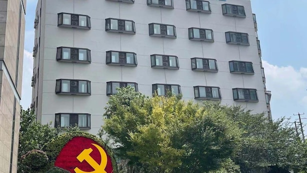 A multi-story hotel building with a modern facade, featuring a series of evenly spaced windows and a logo at the top. - Jinjiang Inn Shanghai East China Normal University (Shanghai)