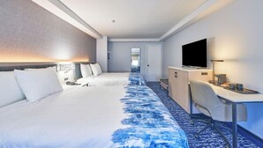 A hotel room with two beds, a desk, a television, and a mirror. - All Seasons Inn And Suites (Buzzards Bay)