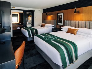 A hotel room with two beds, a desk, a chair, and a bathroom visible through an open door. - Quality Inn Bardstown (Bardstown)