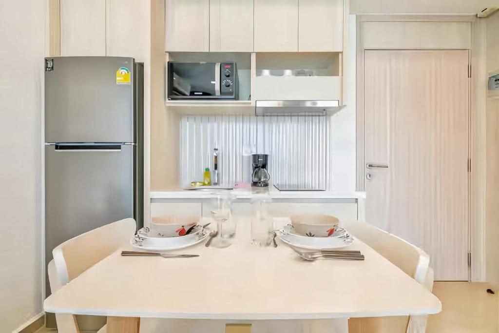 A compact kitchen with a refrigerator, microwave, and coffee maker.