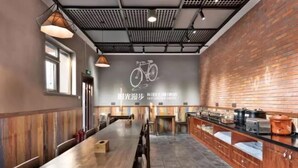A spacious dining area with a long wooden table, brick walls, and a ceiling with a grid pattern. - Time Walk Nostalgic Theme Hotel Beijing Prince Gongfu (Beijing)