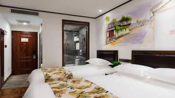 A hotel room with a large bed, a shower area, and a mural on the wall.
