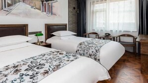 A hotel room with two beds, a mural on the wall, a window with sheer curtains, and a small table with a telephone. - Time Walk Nostalgic Theme Hotel Beijing Prince Gongfu (Beijing)