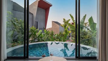 A modern pool area with a clear view of the surrounding architecture and lush greenery.