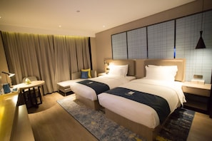 A hotel room with two beds, a small table, a chair, and a large window with curtains. - Echarm Hotel Xiantao Stadium (Beijing)