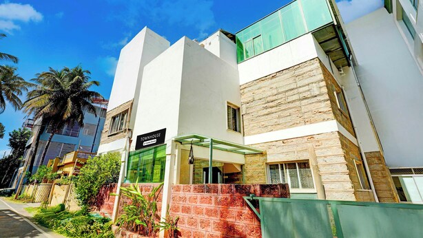 A modern building with a sign indicating it is a serviced company property. - Townhouse Mysuru Sand Museum (Mysore)