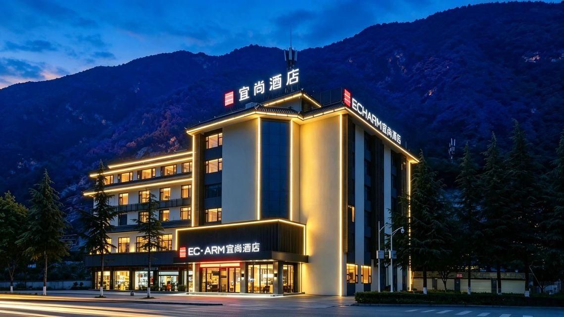A hotel with a modern design, featuring multiple floors and a prominent sign.