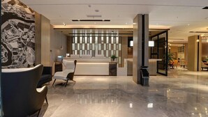 Uma área de recepção moderna com balcão, assentos e parede decorativa.