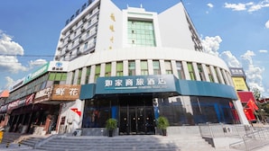 Um hotel com fachada moderna, vários andares e uma entrada notável com degraus.
