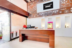 A reception desk with a sign above it, a computer, and a decorative fish tank. - Townhouse Oak Narayanaguda Metro Station (Hyderabad)