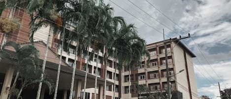 A multi-story hotel with a sign for 'Garden View Hotel' and 'Garden View Club'.