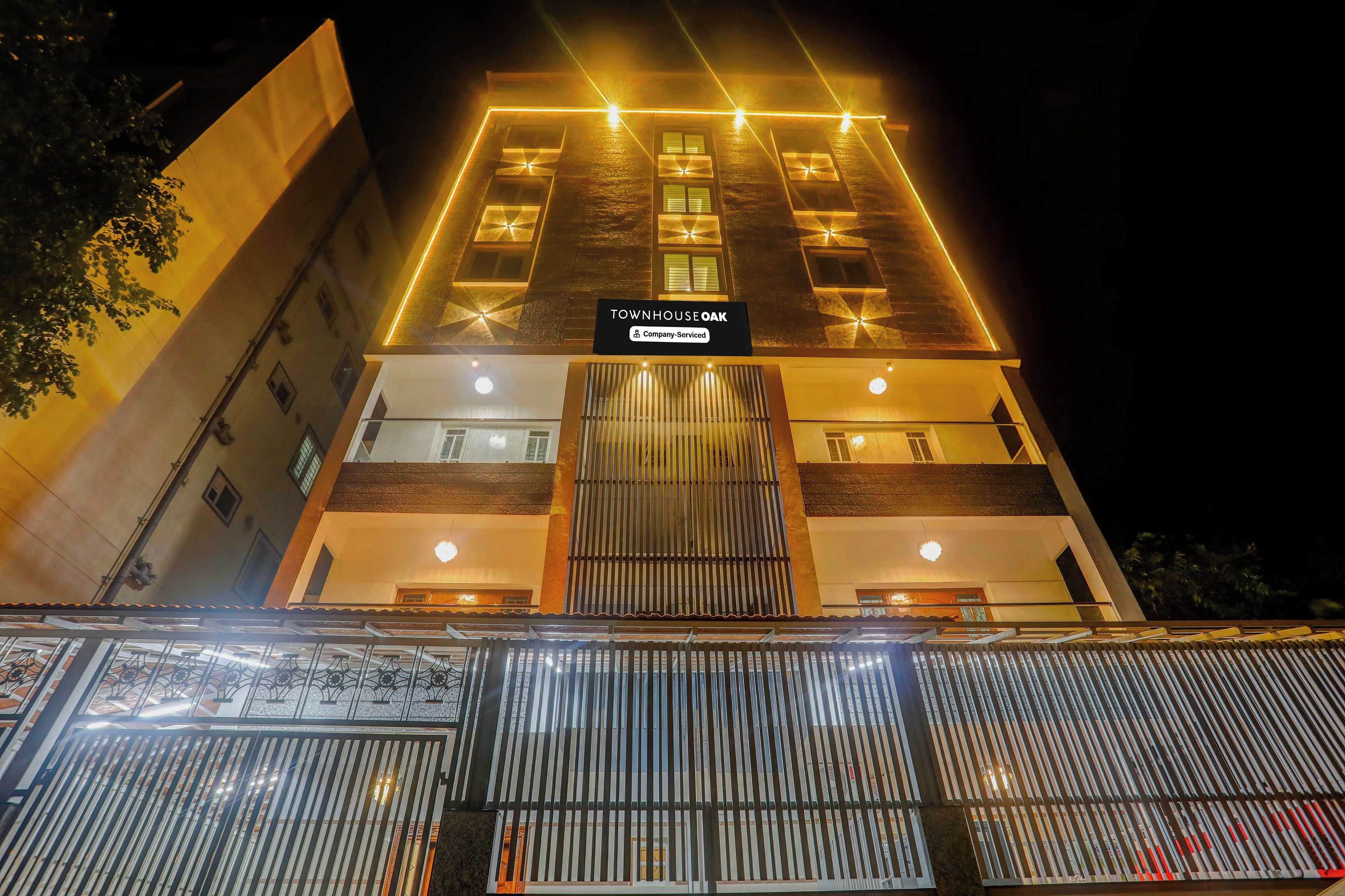 A multi-story building with a sign indicating it is a company-serviced townhouse.