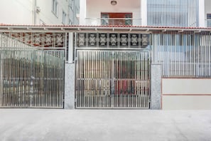 A gated entrance with a metal gate and a decorative metal fence.