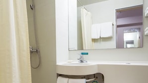 A bathroom with a shower, sink, mirror, and toilet. - Jinjiang Inn (Daqing)