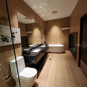A modern bathroom with a toilet, sink, and bathtub. - Azar Hotel Ahad Rafidah (Ahad Rafidah)