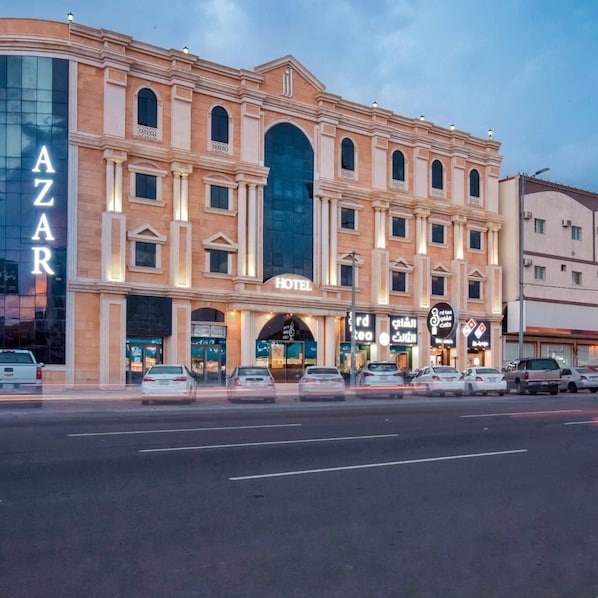 A hotel with a large arched entrance, multiple windows, and a sign indicating it is a hotel. - Azar Hotel Ahad Rafidah (Ahad Rafidah)