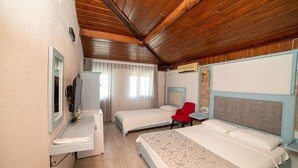 A hotel room with two beds, a desk, a chair, a TV, and a bathroom. - Gokceada Yakamoz Motel (Gökçeada)