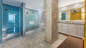 A modern bathroom with a glass shower enclosure, marble flooring, and a large mirror above the sink. - Holiday Inn Express Zhuhai Guishan Island (Zhuhai)