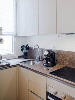 A kitchen with a sink, a coffee maker, and cabinets. - In the Heart of Florence, Just a Stone's Throw from the Duomo (Florence)